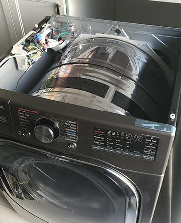 image of partially dismantled washing machine - Is it Worth Repairing Your Washing Machine? Top 5 Expert Tips
