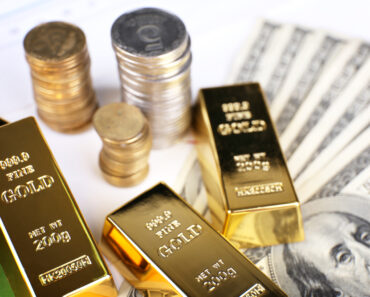 Gold bullion with money on table close up - precious metal markets - https://depositphotos.com/photos/precious-metals.html?filter=all&qview=77457504