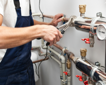 image of plumber working on rough-in work