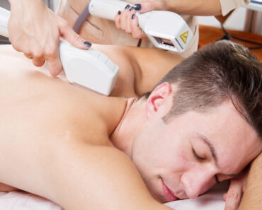 young man receiving laser epilation on beauty center - Laser Removal for Men: A Guide to Hair Removal Solutions
