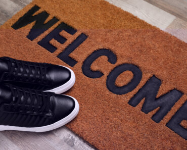 Add Value to Your Home Before Selling - New clean mat with word WELCOME and shoes on floor