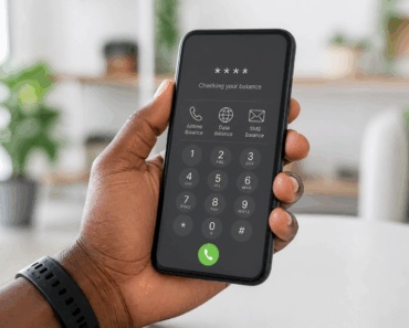 Hand holding a phone displaying airtime, data and SMS balance options